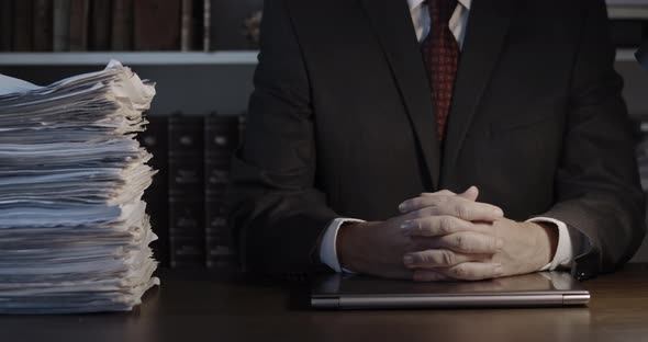 Businessman with Clasped Hands on His Office Desk