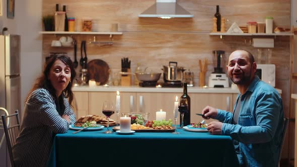 Having Video Call During Romantic Dinner alt