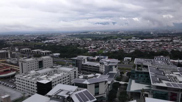 Aerial shot flying over a shopping mall in the city of San Jose, Costa Rica alt