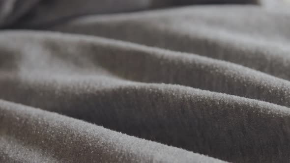 Closeup of Dark Gray Cotton Fabric with Spills Slowmotion
