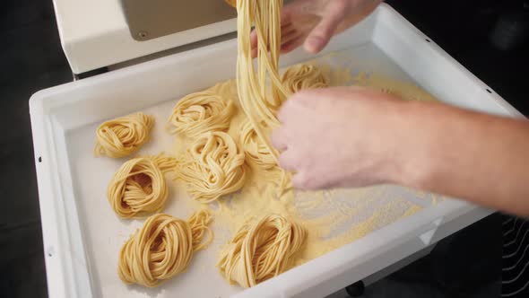 Man Making Fresh Pasta on Traditional Italian Kitchen Machine for Spaghetti Chef Preparing Fresca alt