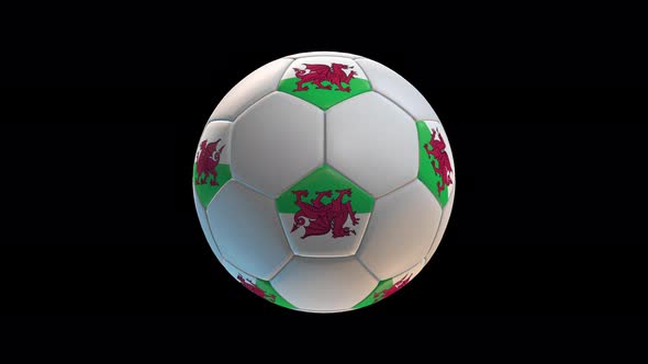 Soccer ball with flag Wales, on black background loop alpha