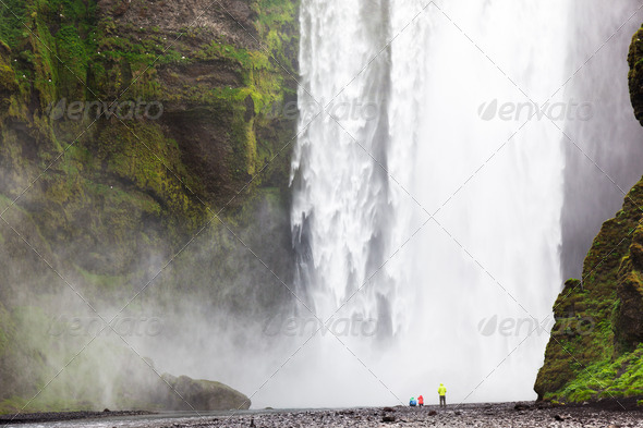 Tourists in front of Skogafoss waterfall - Stock Photo - Images