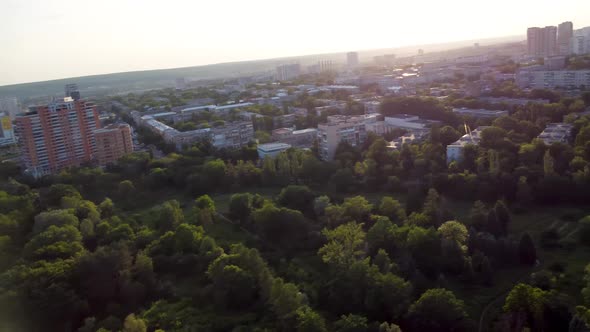 Aerial sunset cityscape with buildings and streets