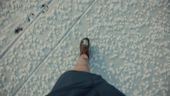 Man Legs Walking In Snow. Male In Snowy Weather At Cold Temperature Walking Alone. Legs Footprints. alt