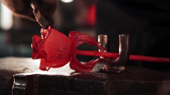 Man Blacksmith Shaping a Rose Out of Metal Using Forceps alt