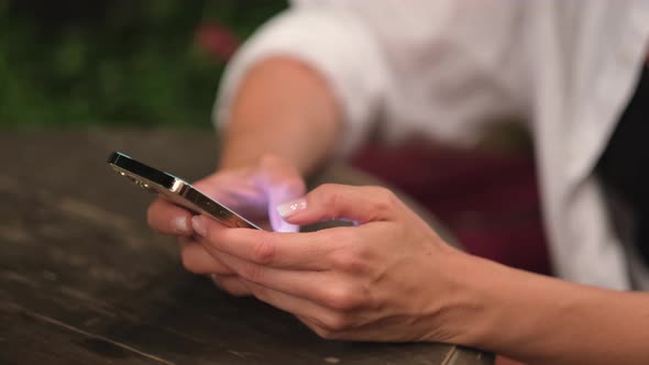 Women's Hands with a Phone alt
