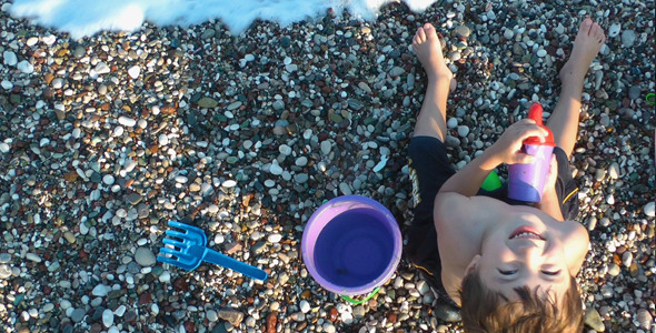 Boy Playing with Toys Near the Seaside alt