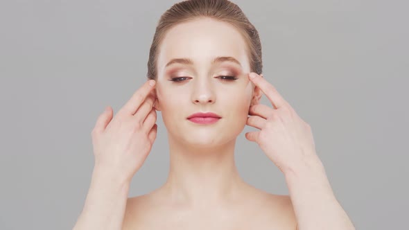 Studio portrait of young, beautiful and natural woman over grey background. alt