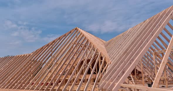 Closeup View of Wooden Beams Rafters Joist with Nail Plywood Panels on the Roof alt