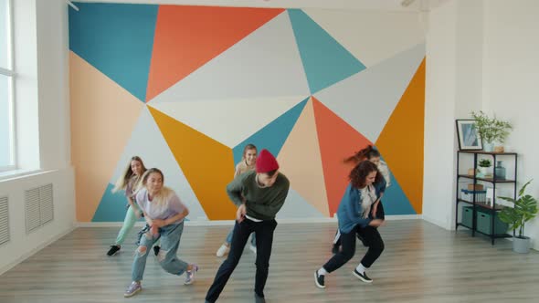 Slow Motion of Active Youth Performing Modern Dance During Lesson in Studio alt