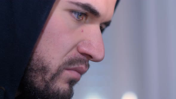 close up on face of hacker concentrated on the computer alt