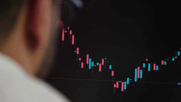 Stockbroker Looking At Stock Market Charts alt