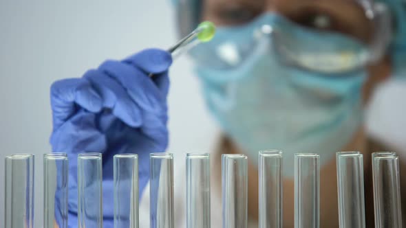 Lab Assistant Examining Green Organic Pill, Pharmaceuticals and Homeopathy alt