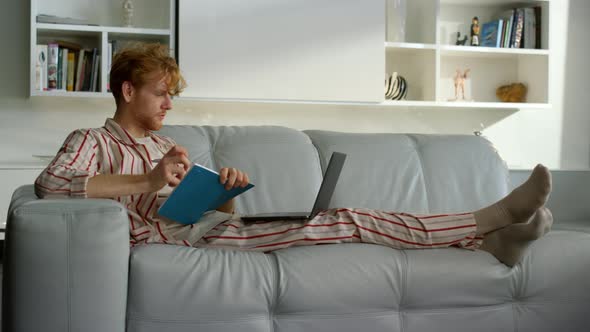 Manager Working Making Notes in Pajamas at Remote Office alt