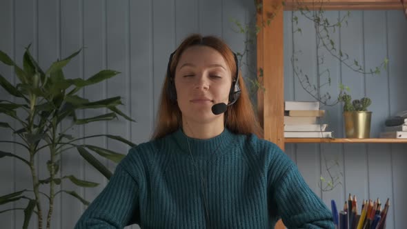 Young Woman in Headset with Microphone Holding Online Meeting Conversation