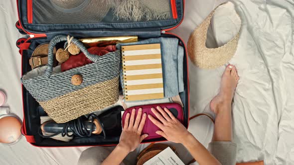 Top View Time-Lapse of Woman Packing Suitcase alt