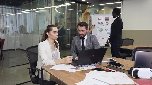 Business Colleagues which Working at the Meeting Table Using Computer alt
