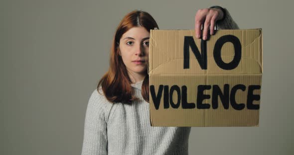 Girl Raises the Sign That Says No Violence and the Hand with Stop War in Protest alt