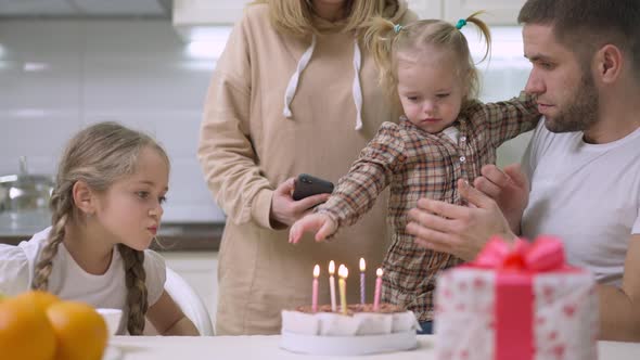 Young Caucasian Family Celebrating Sixth Birthday of Beautiful Girl at Home alt