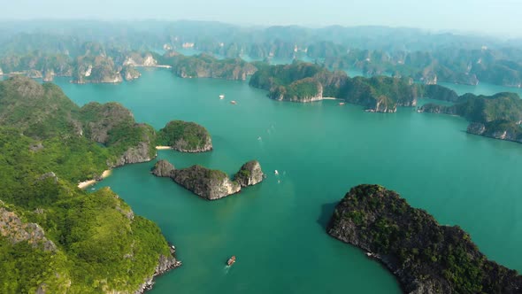 Aerial: flying over Ha Long Bay rock pinnacles, famous tourism destination in Vietnam alt