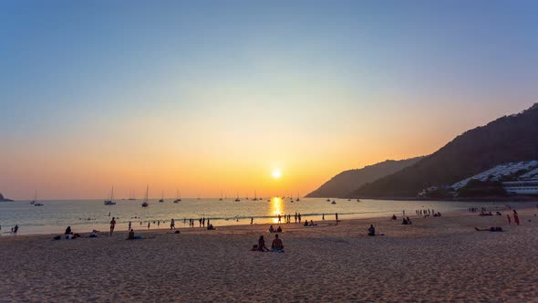 Time Lapse People Relax In Nai Harn Beach At  Sunset alt