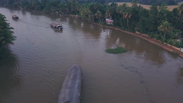 Houseboat tour of Kerala backwaters at Alleppey, India. Aerial drone view alt