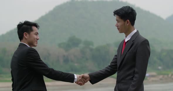 Businessman Handshake And Giving Money alt