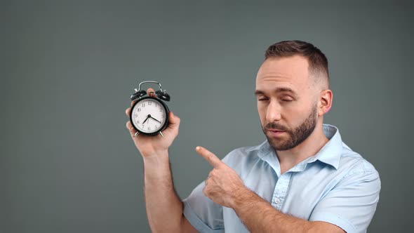 Male Pointing on Alarm Clock Reminding Deadline Limitation alt
