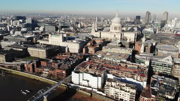 Aerial shot of St Pauls Cathedral and Millennium Bridge on a hazy sunny day alt