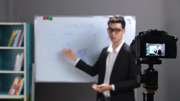 Asian Business Coach Recording Video At Home alt