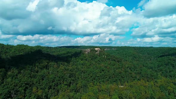 Flying North from Princess Arch toward a rock formation over a beautiful valley of trees. alt