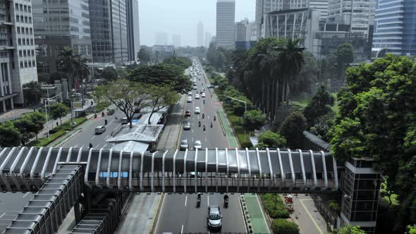 Cinematic aerial view of cityscape and crossing bridge with road traffic