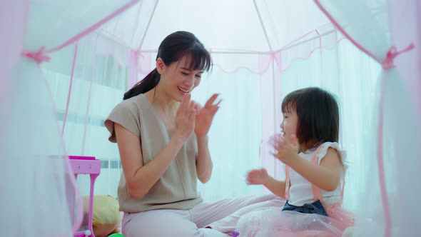 Beautiful loving Parent play education game with little kid to learn and develop speaking skill. alt