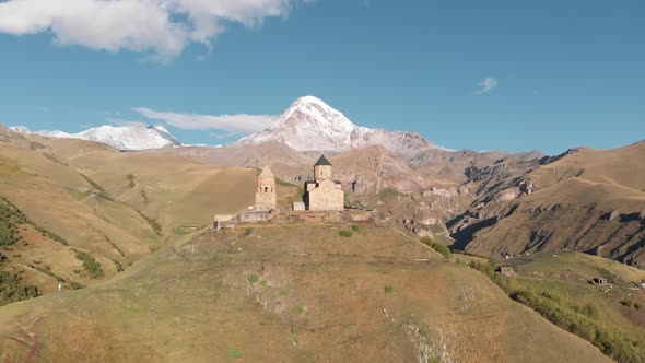 Gergeti Trinity Church in Stepantsminda Mountain Kazbegi at Background Georgia alt