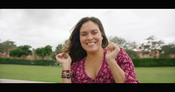 Woman Smiling at Camera While Spinning in Merry Go Round alt