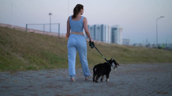 Girl with a Dog for a Walk