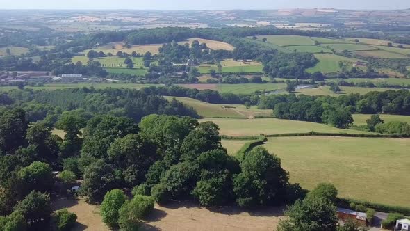 An agricultural landscape of a beautiful countryside during springtime. alt