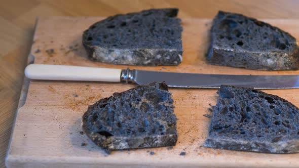 Artisan home-made charcoal sourdough bread freshly sliced with bread knife