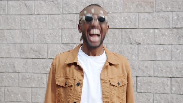 Portrait of Joyful African American Man Laughing and Nodding Standing Outdoors alt
