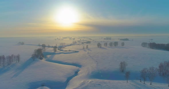 Aerial View of Cold Winter Landscape Arctic Field Trees Covered with Frost Snow Ice River and Sun alt