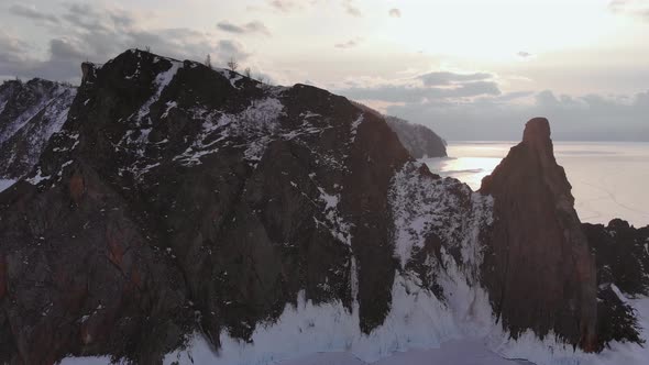 Aerial View of Winter Landscape of Rocky Mountains on Lake Baikal. alt