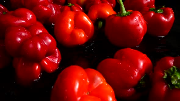 The bell sweet peppers falling into the water. Slow motion. alt