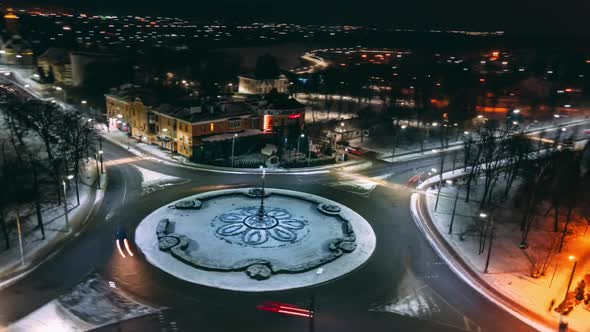 Aerial View Night Timelapse of Roundabout Road with Circular Cars in Small European City alt