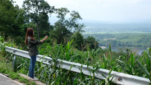 A female tourist shooting video by an action camera