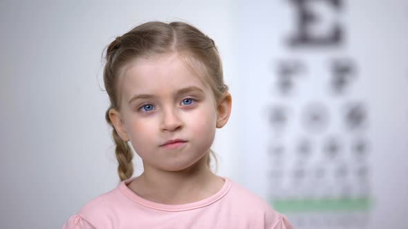 Child Testing Vision With Magnifier, Diagnosis of Cornea, Eyesight Illness alt