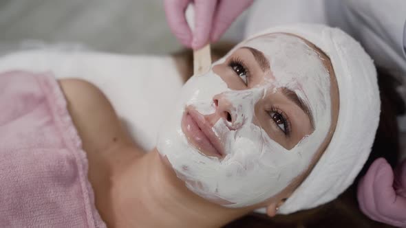 View of Spa Procedure of Applying Clay Mask on Female Face in a Beauty Salon alt
