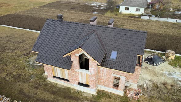 Aerial View of House Roof Top Covered with Ceramic Shingles alt