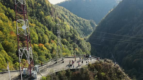 Aerial drone view of nature in Romania. Valley in Carpathian mountains with viewpoint full of people alt
