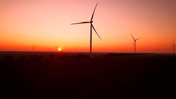 Wind Turbines Generate Electricity at Station Against Sunset